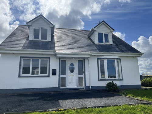 Modern white bungalow with slate roof and dormer windows in Co. Clare, Ireland - Ard Na Mara apartment