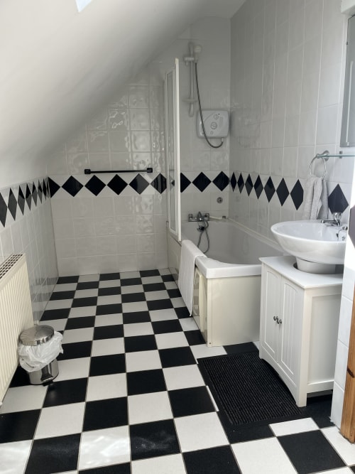 Modern bathroom at Ard Na Mara, Bucket & Spade hotel in Co. Clare with black and white checkered tiles