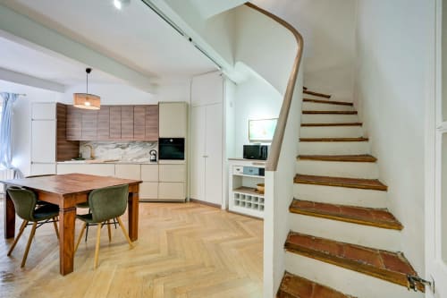 Suite Mirabeau kitchen and dining area with wooden stairs at Les Suites de Montigny, Aix-en-Provence