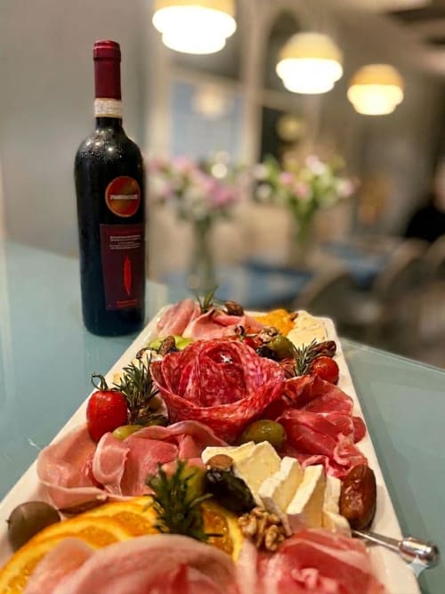 Tagliere di salumi e formaggi con vino rosso presso Villa Oteri Rooms & Bistrot a Bacoli, Napoli