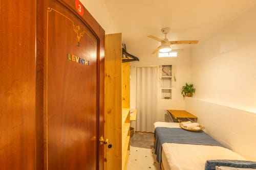 Leveche room at Casa de Océano hotel in Tarifa with twin beds, wooden wardrobe, and ceiling fan