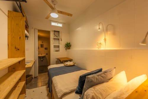 Leveche room at Casa de Océano, Tarifa: cozy bedroom with twin beds, wooden furnishings, and modern bathroom fixtures
