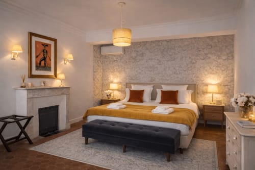 Suite Mirabeau at Les Suites de Montigny in Aix-en-Provence featuring elegant bedroom with fireplace and garden view