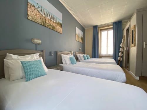 Quadruple bedroom at Hôtel Maison Richet in Les Sables-d'Olonne with double bed, twin beds, blue accents, and modern