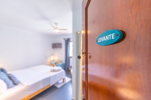 Blue 'Levante' room nameplate on wooden door at Casa de Océano hotel in Tarifa