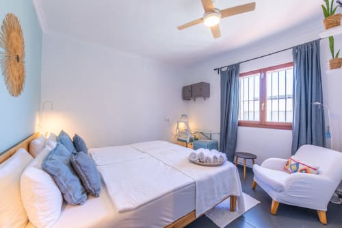 Levante room at Casa de Océano hotel in Tarifa with double bed, single bed, and modern coastal decor