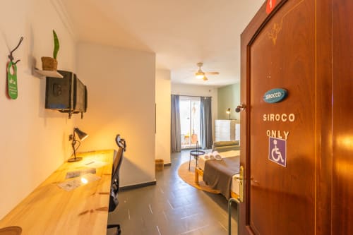 Sirocco wheelchair-accessible room at Casa de Océano hotel in Tarifa with desk, sitting area, and balcony