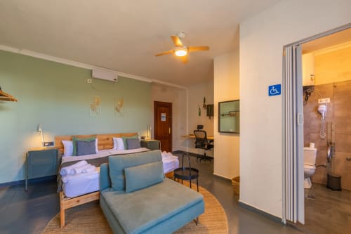Sirocco room at Casa de Océano, Tarifa - wheelchair accessible bedroom with bed, seating, work desk and ensuite bathroom