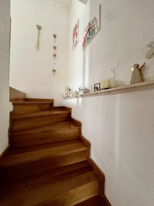 Scala in legno nell'appartamento Il Narciso del Subasio a Le Colline della Speranza, Spello Umbria, con pareti bianche e
