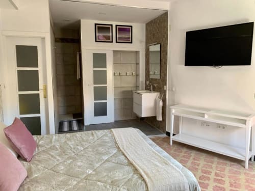 Modernes Schlafzimmer mit eigenem Bad, Flachbildfernseher und Stadtblick in Santa Cruz de Tenerife