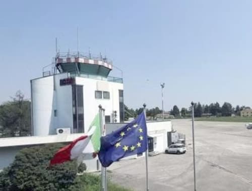 Air traffic control tower at Padova airport with Italian and EU flags