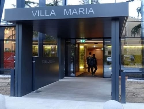 Villa Maria entrance at Palazzo Vittoria in Padova, Italy - modern B&B with blue facade and glass doors