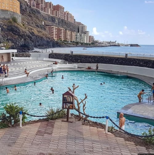 Oceanfront pool at Tabaiba apartment in Santa Cruz de Tenerife with beach views and coastal buildings