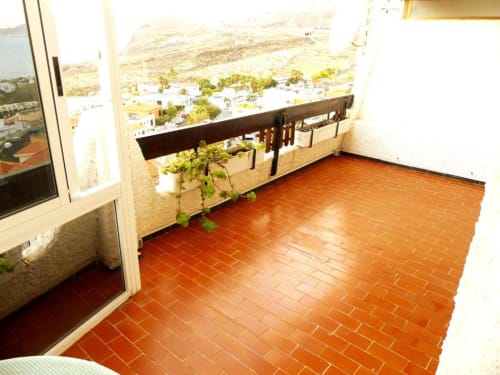 Spacious terrace at Tabaiba Ocean View apartment in Santa Cruz de Tenerife with terracotta tiles, sea view, and outdoor