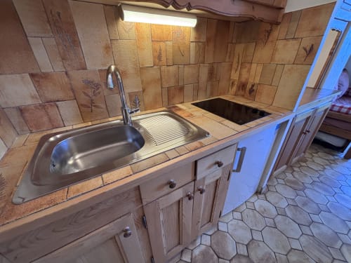 Kitchen sink and stove in Chez Francine studio apartment, Notre Dame de Bellecombe