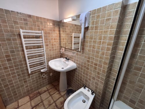 Bathroom in Studio Ban rouge at Chez Francine, Notre Dame de Bellecombe, with pedestal sink, bidet, heated towel rail, and
