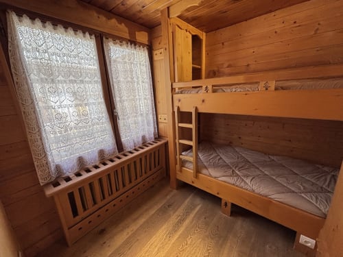 Cozy wooden bunk bed bedroom with lace curtains at Chez Francine apartment, Notre Dame de Bellecombe