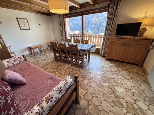Spacious apartment at Chez Francine with mountain views, bed, dining area, TV, and balcony overlooking Notre Dame de