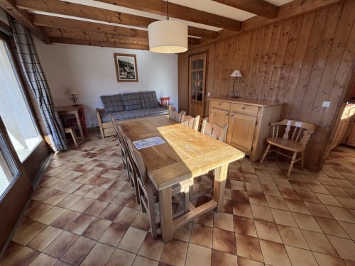 Spacious wood-paneled dining area with wooden table and chairs at Chez Francine apartment in Notre Dame de Bellecombe