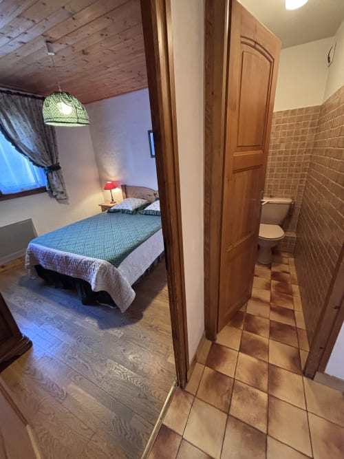 Bedroom and bathroom view at Chez Francine apartment in Notre Dame de Bellecombe, France