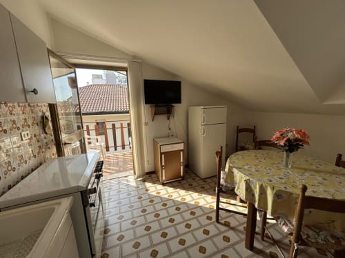 Cozy apartment bedroom and kitchen at Villa Loris, Anthea Hotel Lignano Sabbiadoro, with balcony view and modern amenities