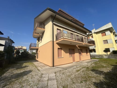 Villa Loris 2 exterior at Anthea Hotel, Lignano Sabbiadoro, with peach facade, balconies and garden view