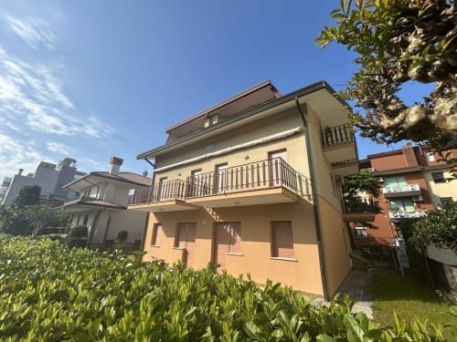 Villa Loris 2 at Hotel Anthea in Lignano Sabbiadoro with garden view, balcony, and city skyline backdrop