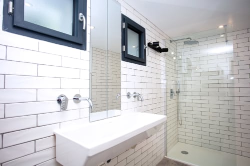 Modern bathroom in Villa Granières at Locavilla with subway tile walls, floating vanity, and walk-in shower