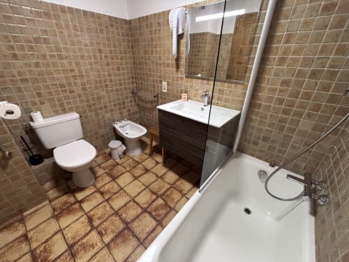Modern bathroom in Studio Aravis at Chez Francine, Notre Dame de Bellecombe, featuring tiled walls, shower, sink, and toilet
