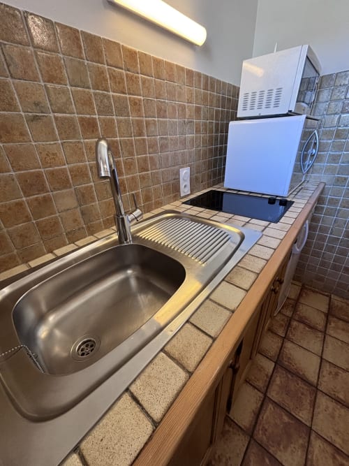 Compact kitchen sink with stainless steel basin and drainboard at Chez Francine hotel apartment, Notre Dame de Bellecombe