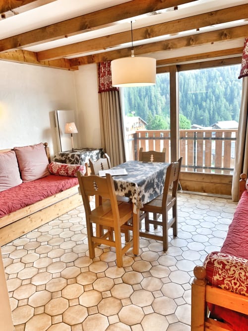 Studio Lachat at Chez Francine with mountain views, wooden beams, red accents, and alpine décor