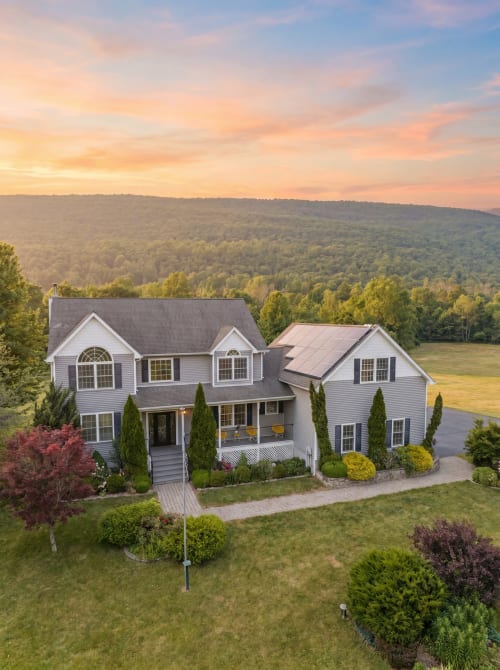 Malkita Aria Mountainview Retreat villa in Highland Mills with mountain views, white exterior, landscaped grounds, and