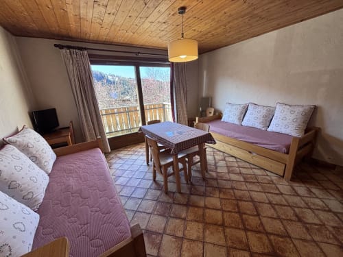 Studio apartment at Chez Francine in Notre Dame de Bellecombe with twin beds, wooden ceiling, and mountain balcony view