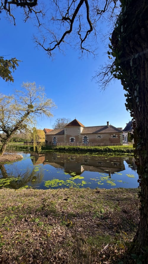 Historic cottage at Cloffy B&B in Nouans-les-Fontaines with lily pond and clear blue sky view