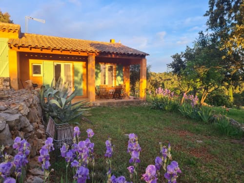 Charming yellow villa at Domaine de L'Échappée Belle in Entrecasteaux with purple iris flowers and terrace