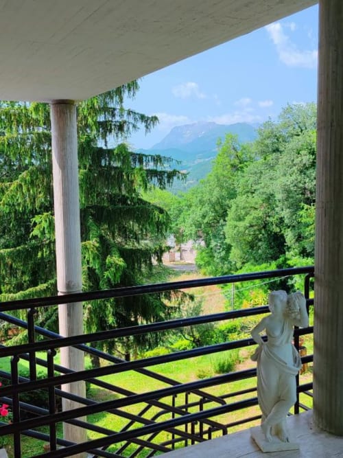 Balcone di Villa Andreina con vista sulla valle di Sarnano, montagne, paesaggio verde e ringhiera della terrazza
