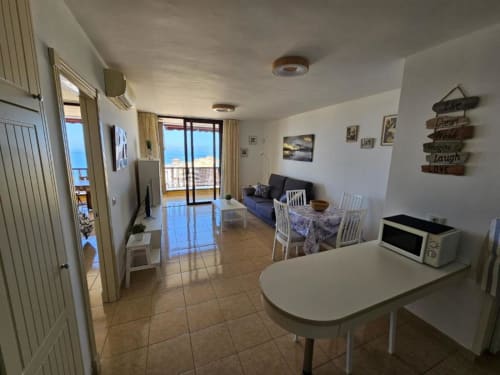Modern apartment in Tenerife with ocean view, kitchenette, dining area, sofa bed, and sea-view balcony