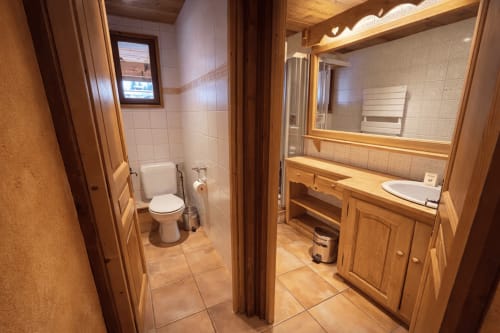Bathroom in La Chambre Chez Marion at Chez Francine hotel, Notre Dame de Bellecombe, featuring toilet, sink with mirror, and