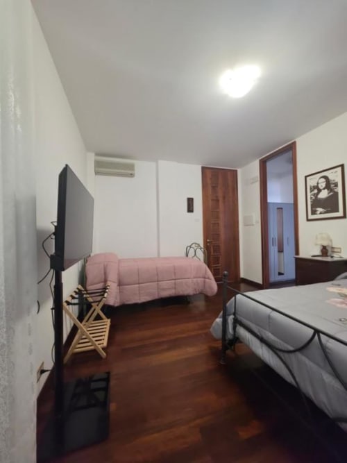 Room 4 at Villa Andreina B&B in Sarnano with double bed, extra bed, TV, and garden view