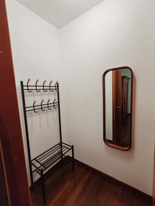 Room 4 entrance at Villa Andreina B&B in Sarnano with coat rack, mirror, and wooden flooring