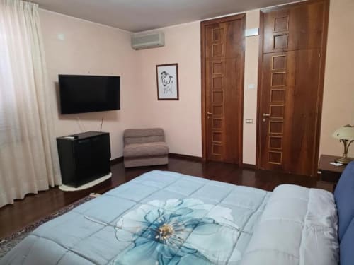 Room No.1 Suite at Villa Andreina B&B in Sarnano with queen bed, TV, AC, and wooden doors