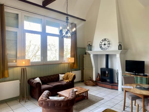 Geräumiges Wohnzimmer mit Burgunder-Sofa, Kamin und Meerblick in Destination Etretat, Normandie