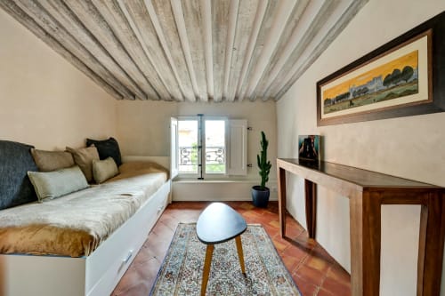 Suite Cézanne at Les Suites de Montigny in Aix-en-Provence: daybed with cushions, exposed beam ceiling, garden view doors,