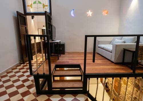 Stylish bedroom at Villa Merida Boutique Hotel in Merida with modern furniture, decorative moon and star lights, and