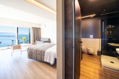 Suite Premium dell'Hotel Belvedere Resort con vista sulla baia di Castellammare del Golfo, letto, balcone e bagno moderno