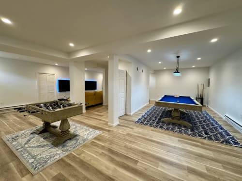 Game room at Malkita Homes in Highland Mills with foosball, pool table, and flat-screen TVs