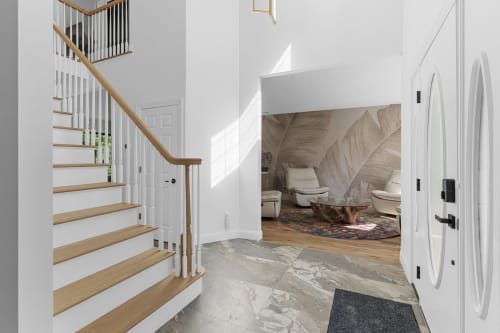 Modern entryway at Malkita Homes in Highland Mills with wooden staircase, marble flooring, and open loft bedroom above