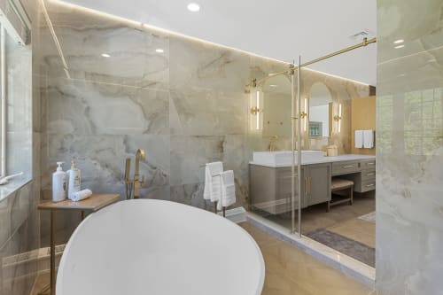 Luxury bathroom at Malkita Homes with marble shower, freestanding soaking tub, and dual vanity in Highland Mills