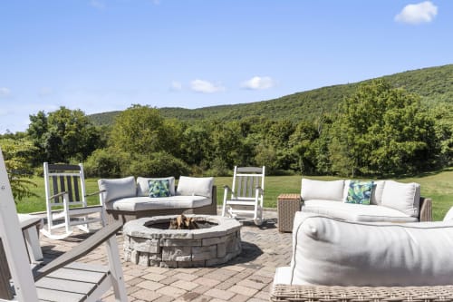 Outdoor patio at Malkita Homes Highland Mills with fire pit, comfortable seating, and mountain views
