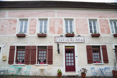 La maison d'hôtes Le Coin des Artistes à Giverny avec sa façade en pierre rose, volets rouges et terrasse charmante